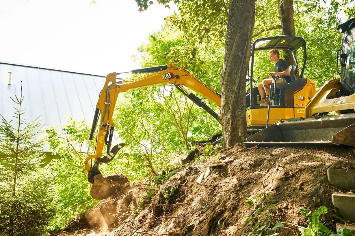 Excavator digging into a hillside