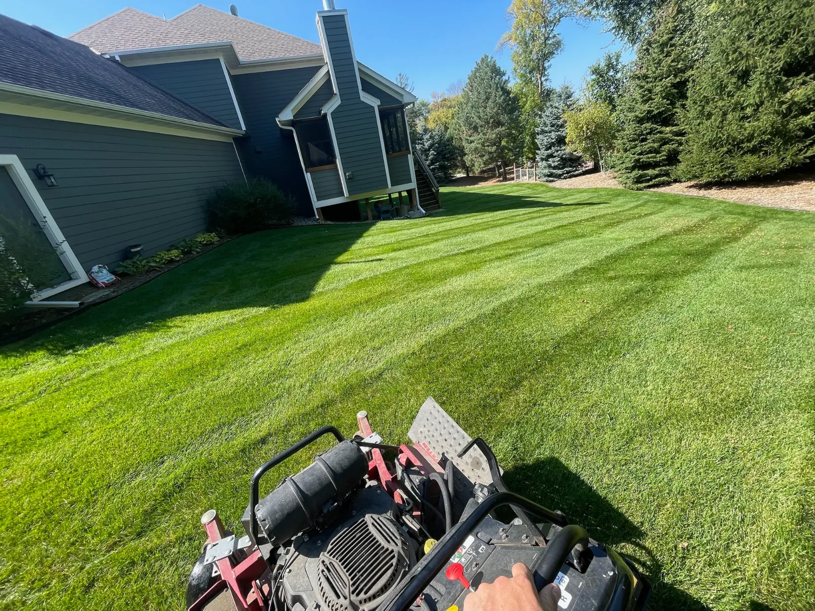 POV from a commercial zero-turn mower executing clean turf cuts