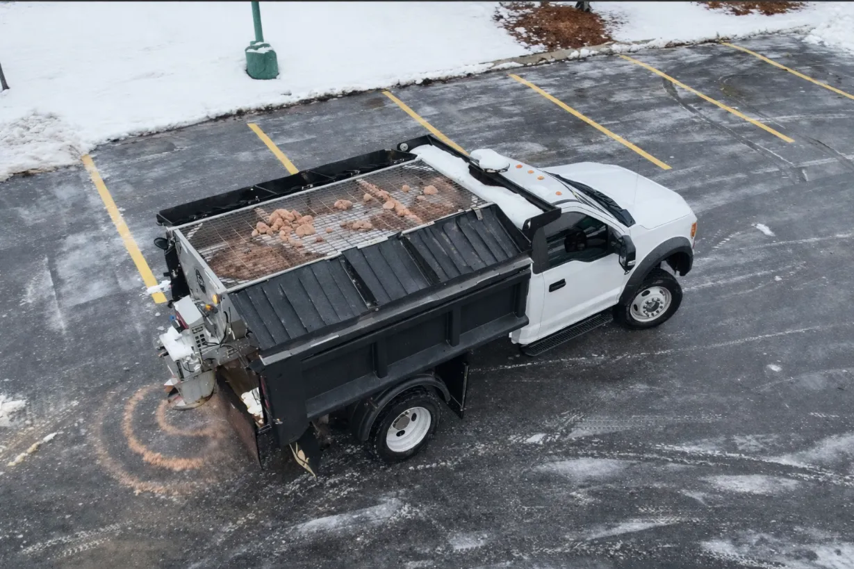 Commercial truck spreading high performance salt in a West Metro parking lot