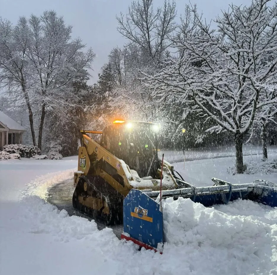 Heavy-duty snow blower clearing a frozen sidewalk in Minnesota